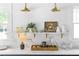 Open shelving displays decor in this kitchen with white quartz countertops and gold accents at 291 Elmira Ne Pl, Atlanta, GA 30307