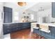 Kitchen with blue cabinets, quartz countertops and bar seating at 291 Elmira Ne Pl, Atlanta, GA 30307