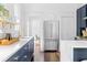Bright kitchen with stainless steel refrigerator, quartz counters, and blue cabinets at 291 Elmira Ne Pl, Atlanta, GA 30307