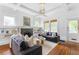 Bright living room with hardwood floors, coffered ceilings, a fireplace, and built-in bookshelves at 291 Elmira Ne Pl, Atlanta, GA 30307