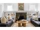 Bright living room featuring a fireplace with built-in bookshelves and classic hardwood floors at 291 Elmira Ne Pl, Atlanta, GA 30307