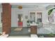 Charming front porch with brick columns, a cozy seating area, and view of the neighborhood at 291 Elmira Ne Pl, Atlanta, GA 30307