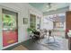 Cozy front porch features seating, a small table, and vibrant plants, creating an inviting outdoor space at 291 Elmira Ne Pl, Atlanta, GA 30307