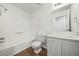 Bright bathroom with a shower-tub combo, new toilet, and vanity with a sink at 5570 Deerfield Nw Pl, Kennesaw, GA 30144