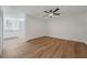 Cozy bedroom featuring hardwood flooring, a ceiling fan, and an adjacent kitchenette at 5570 Deerfield Nw Pl, Kennesaw, GA 30144