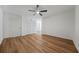 Spacious bedroom featuring new hardwood floors, ceiling fan, and ample closet space at 5570 Deerfield Nw Pl, Kennesaw, GA 30144