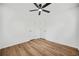Bedroom with hardwood floors, neutral white walls, and a ceiling fan at 5570 Deerfield Nw Pl, Kennesaw, GA 30144