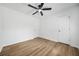 Bedroom with hardwood floors and a ceiling fan, offering ample space and natural light at 5570 Deerfield Nw Pl, Kennesaw, GA 30144