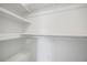 This spacious walk-in closet has built-in shelving and a place to hang your clothes at 5570 Deerfield Nw Pl, Kennesaw, GA 30144