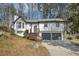 Exterior view of a two-story house, a driveway, and a two-car garage at 5570 Deerfield Nw Pl, Kennesaw, GA 30144