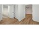 Hallway featuring hard wood floors, stairs, closet, and a doorway to a bedroom at 5570 Deerfield Nw Pl, Kennesaw, GA 30144