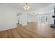 Open-concept living area with hardwood floors, fireplace, and seamless transition to kitchen at 5570 Deerfield Nw Pl, Kennesaw, GA 30144