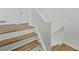 View of the stairway with wood flooring and white railings at 5570 Deerfield Nw Pl, Kennesaw, GA 30144