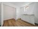 Bright utility room equipped with a sink, cabinets, and new hardwood flooring at 5570 Deerfield Nw Pl, Kennesaw, GA 30144