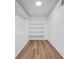 Well-organized walk-in closet with built-in shelving and ample storage space at 5570 Deerfield Nw Pl, Kennesaw, GA 30144
