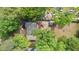 Aerial view of a wooded property with a cozy home nestled among mature trees at 715 Wood Valley Rd, Mableton, GA 30126