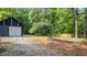 Backyard with a shed, greenery and a fire pit at 715 Wood Valley Rd, Mableton, GA 30126