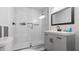Modern bathroom featuring a tiled shower, vanity, and a large mirror at 715 Wood Valley Rd, Mableton, GA 30126