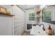 Charming bathroom featuring a striped shower curtain, modern sink, and stylish wooden shelves at 715 Wood Valley Rd, Mableton, GA 30126