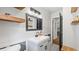 Bright bathroom with a modern sink, sleek vanity, floating shelves, and stylish mirror at 715 Wood Valley Rd, Mableton, GA 30126