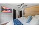 Modern bedroom with light walls, a ceiling fan, TV, and closet at 715 Wood Valley Rd, Mableton, GA 30126