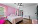 Pink bedroom with closet and a make-up vanity, hardwood floor and natural light at 715 Wood Valley Rd, Mableton, GA 30126