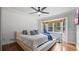 Cozy bedroom with hardwood floors, ceiling fan, and a window seat overlooking the backyard at 715 Wood Valley Rd, Mableton, GA 30126