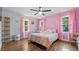 Pink themed bedroom features hardwood floors, closet, and natural light at 715 Wood Valley Rd, Mableton, GA 30126