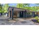 View of the carport showing the brick and wood accent siding and its convenient access to the main house at 715 Wood Valley Rd, Mableton, GA 30126