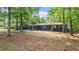 Landscaped front yard of the home with its mature trees and inviting curb appeal at 715 Wood Valley Rd, Mableton, GA 30126