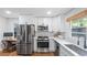 Modern kitchen features stainless steel appliances, white cabinets, and butcher block counters at 715 Wood Valley Rd, Mableton, GA 30126
