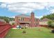 Large fenced backyard with a well-manicured lawn and a patio at 2120 Cain Commons Dr, Dacula, GA 30019