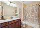 Bathroom showcasing a vanity with drawers, a decorative mirror and a shower with patterned shower curtain at 2120 Cain Commons Dr, Dacula, GA 30019