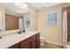 Bathroom features a large mirror, modern vanity, and shower with tiled surround at 2120 Cain Commons Dr, Dacula, GA 30019