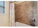 Close-up on bathroom shower with bronze fixtures and floral shower curtain at 2120 Cain Commons Dr, Dacula, GA 30019