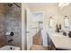 Bathroom features a vanity, tiled shower, and an entryway to the hallway at 2120 Cain Commons Dr, Dacula, GA 30019