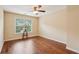 Well-lit bedroom features hardwood floors, natural light, and neutral paint at 2120 Cain Commons Dr, Dacula, GA 30019