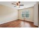 Cozy bedroom features hardwood floors, natural light, and neutral paint at 2120 Cain Commons Dr, Dacula, GA 30019