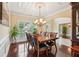 Elegant dining room with hardwood floors, coffered ceilings, and a chandelier at 2120 Cain Commons Dr, Dacula, GA 30019