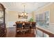 Formal dining room with hardwood floors, elegant chandelier, and wainscoting for sophisticated dinners at 2120 Cain Commons Dr, Dacula, GA 30019