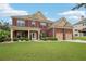 Charming two-story brick home with a well-manicured lawn and attached two car garage at 2120 Cain Commons Dr, Dacula, GA 30019