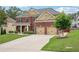 Charming two-story brick home with a well-manicured lawn and attached two car garage at 2120 Cain Commons Dr, Dacula, GA 30019