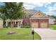Charming two-story brick home with a well-manicured lawn and attached two car garage at 2120 Cain Commons Dr, Dacula, GA 30019