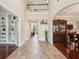 Welcoming foyer with tile flooring, two-story ceiling, and elegant display cabinet makes a great first impression at 2120 Cain Commons Dr, Dacula, GA 30019
