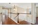 Upstairs hallway with hardwood floors and decorative lighting fixtures at 2120 Cain Commons Dr, Dacula, GA 30019