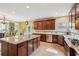Well-designed kitchen with granite island, dark cabinetry, and stainless steel appliances provides style and function at 2120 Cain Commons Dr, Dacula, GA 30019