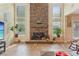 Bright living room features a stone fireplace, large windows, and tiled floors for a cozy atmosphere at 2120 Cain Commons Dr, Dacula, GA 30019