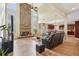 Spacious living room with a stone fireplace, tall ceilings, and tile flooring at 2120 Cain Commons Dr, Dacula, GA 30019