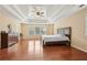 A spacious bedroom with hardwood floors, a trey ceiling, and a ceiling fan at 2120 Cain Commons Dr, Dacula, GA 30019