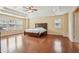 Large bedroom features a trey ceiling, hardwood floors, and multiple windows at 2120 Cain Commons Dr, Dacula, GA 30019